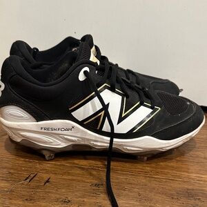 New Balance Black and White Metal Cleats with Gold Detail